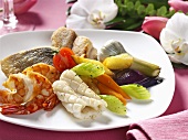 Plate of grilled fish and seafood with vegetables