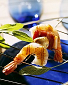 Shrimps on skewer with bacon and mushrooms