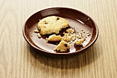 Broken chocolate chip cookie on a plate
