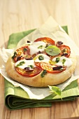 Mini-pizza with tomato and mozzarella topping
