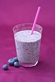 Glass of blueberry buttermilk with straw