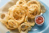 Battered, deep-fried onion rings with ketchup