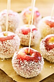 Toffee apples with grated coconut