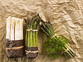 White and green asparagus on paper
