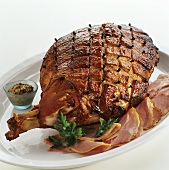 Glazed roast ham with cloves and mustard