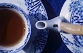 Teapot and teacup filled with tea