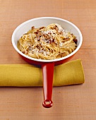 Spaghetti carbonara in a frying pan