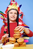 Boy dressed as Red Indian with muffins