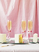 Three pieces of wedding cake on plates, champagne