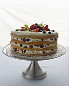 Layer cake filled with cream and fresh berries