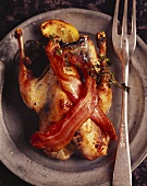Roast quail with rashers of bacon