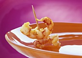 Appetiser: prawns on cocktail stick on a plate