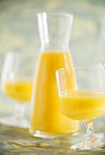 Orange juice in glasses and carafe