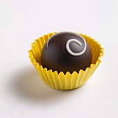 A chocolate in a yellow paper case