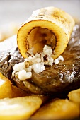 Rib eye steak with fried potato wedges and marrow bone