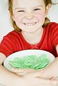 Smiling girl with a dish of Sour Apple Rings