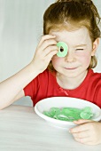 Girl looking through a Sour Apple Ring