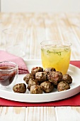 Meatballs and a glass of orange juice on a tray