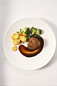 Pork fillet in beer sauce with fried potatoes and broccoli