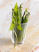 Pea pods in a glass