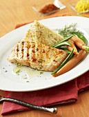 Grilled salmon fillet with pyramid of rice and vegetables