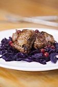 Venison fillet on red cabbage with cranberries