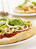 Mushroom, onion and pepper pizza with basil