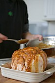 Spooning glaze over roast ham (for Christmas)