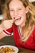 Laughing teenager eating chips