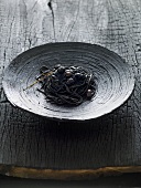 Black tagliatelle with olives and caviar