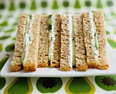 Cucumber and cream cheese sandwiches on a platter