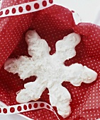 Biscuit in the shape of a snowflake in a gift box