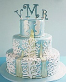 Three-tiered cake with seaweed, sea horses, initials