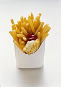 Chips with ketchup and mayo in white fast food box