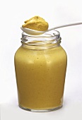 A Jar of Yellow Mustard with Spoonful