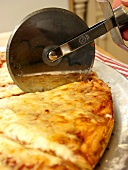 Cutting a Cheese Pizza with a Pizza Cutter