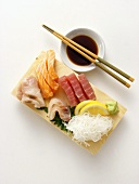 A Sushi Assortment with Sauce and Chopsticks