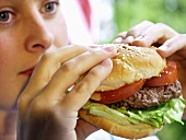 A Woman Holding a Hamburger