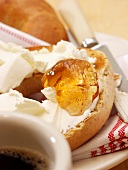 A Toasted Bagel with Cream Cheese, Jelly and Coffee