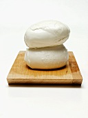 Two Balls of Mozzerella Cheese on Wooden Board