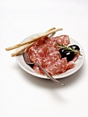Plate of Salami with Olives and Bread Sticks