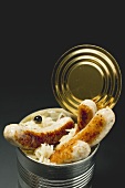 Sausages with sauerkraut in a food tin