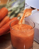 Carrot juice running out of a juicer