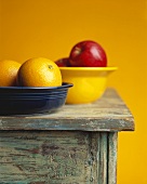 Two Bowls of Fruit on a Table; Oranges and Apples