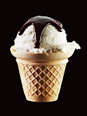 Vanilla ice cream with chocolate sauce in cone