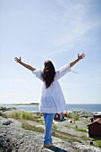 A woman on a rocky beach in Scandinavia