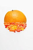 Vitamin tablets and an orange