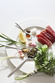 Raw tuna, a bunch of herbs, capers and spring onions