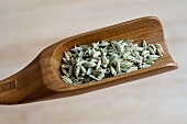 Fennel seeds on a wooden scoop