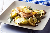 Salmon fillet with potatoes, lemons and feta cheese